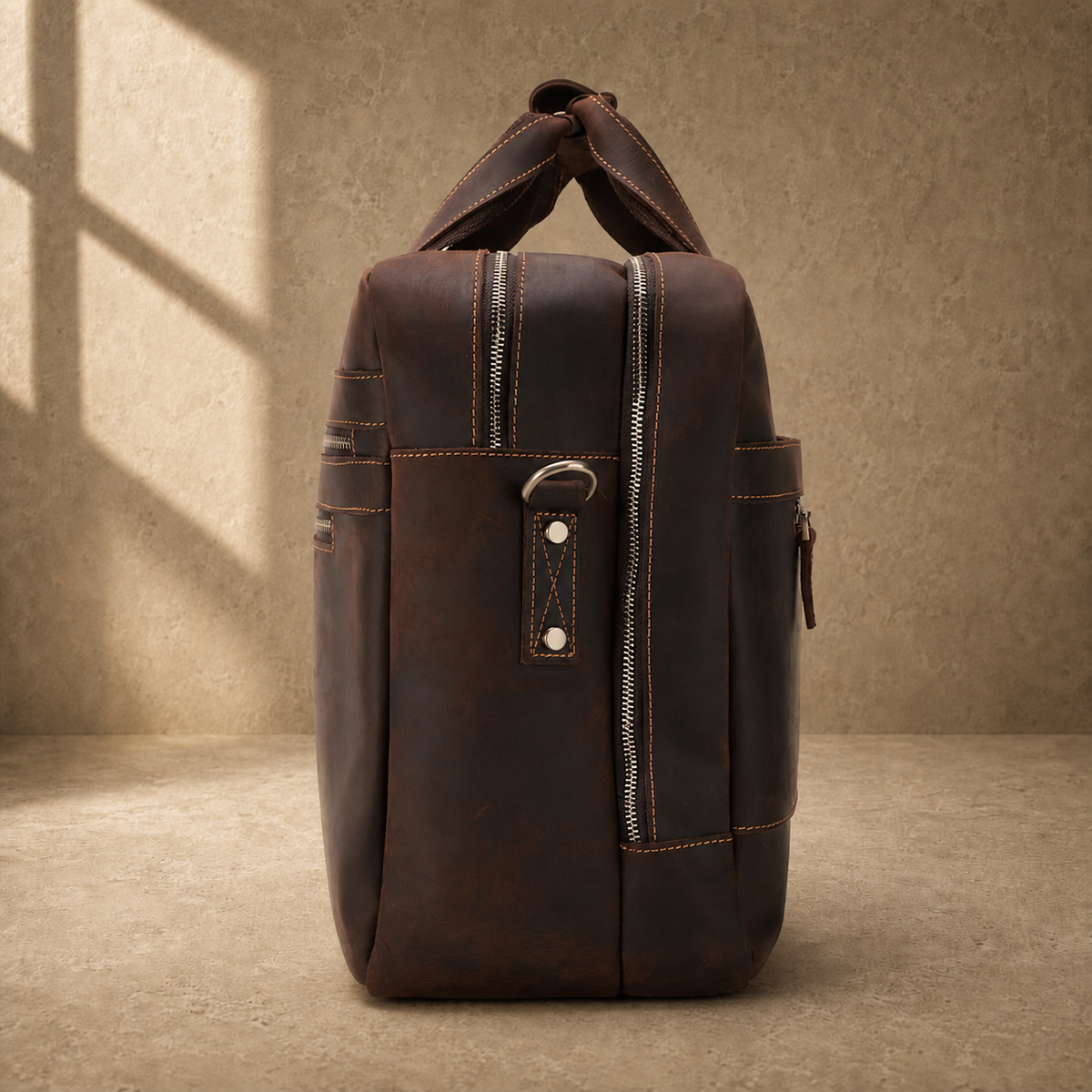 Dark brown cowhide 17-inch briefcase side profile and strap ring