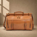Cognac cowhide structured travel bag with shoulder strap, front view
