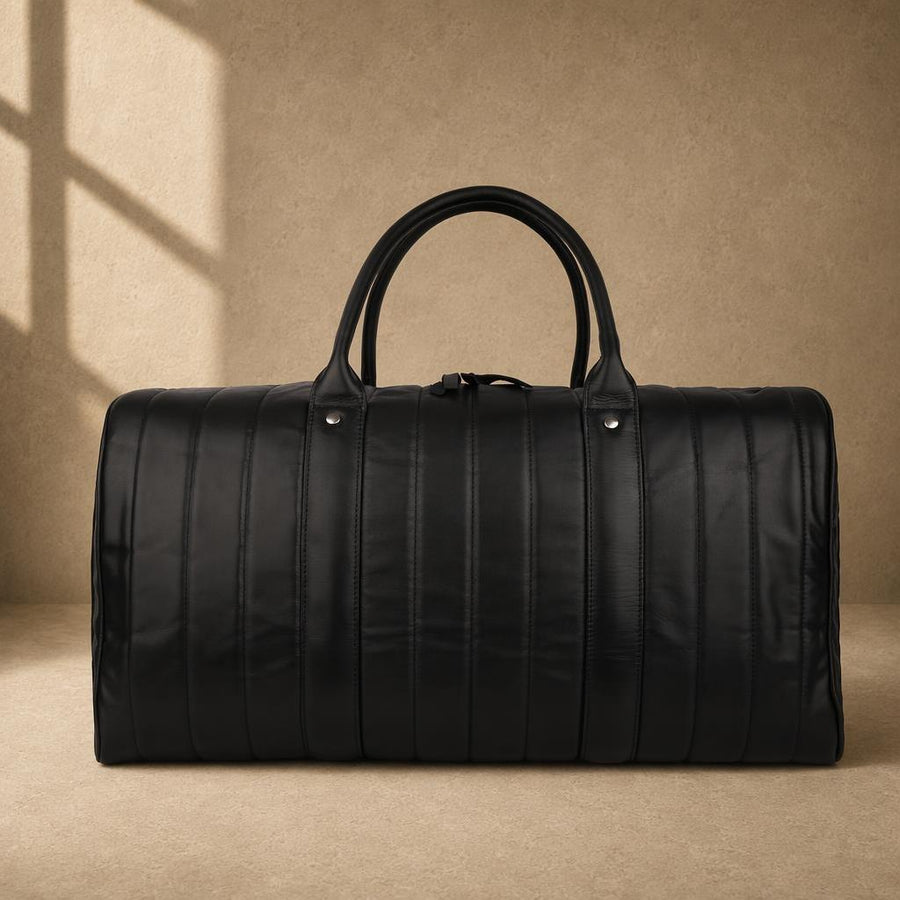 Black quilted cowhide travel duffel, front view