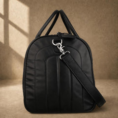 Black quilted cowhide travel duffel, side profile with shoulder strap