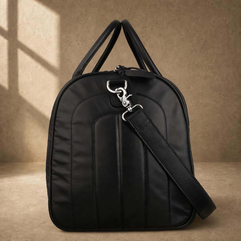 Black quilted cowhide travel duffel, side profile with shoulder strap