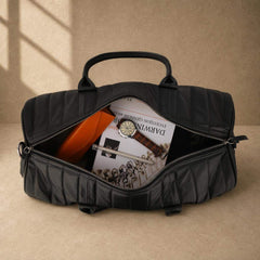 Black quilted cowhide travel duffel showing organized capacity