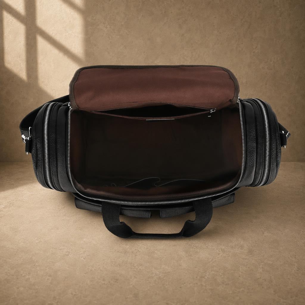 Black pebbled cowhide utility duffel showing empty main compartment