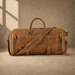 Brown leather travel bag with shoulder strap across the front