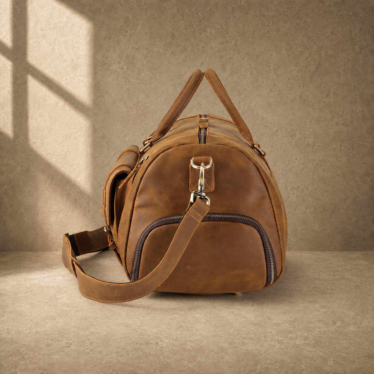 Brown leather shoe pocket travel bag, left end view