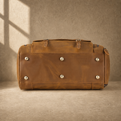 Brown leather travel bag showing protective metal base feet