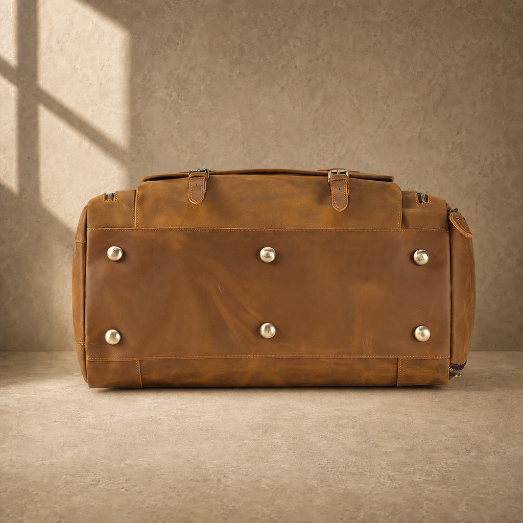Brown leather travel bag showing protective metal base feet