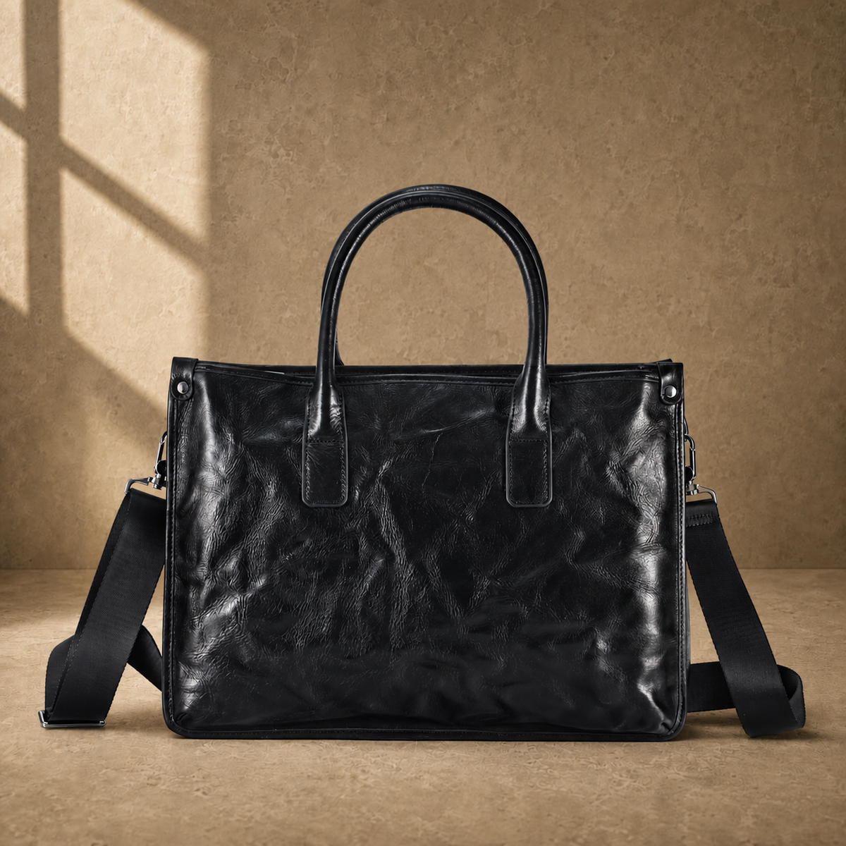 Black vegetable-tanned leather work briefcase front view with shoulder strap