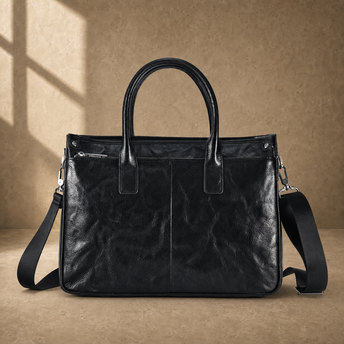 Black vegetable-tanned leather work briefcase rear view with shoulder strap