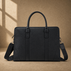 Black vegetable-tanned leather briefcase, front view with shoulder strap