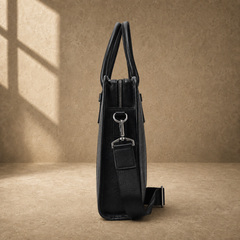 Black vegetable-tanned leather briefcase, side profile and strap hardware