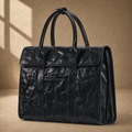 Black wrinkled leather briefcase, three-quarter front view