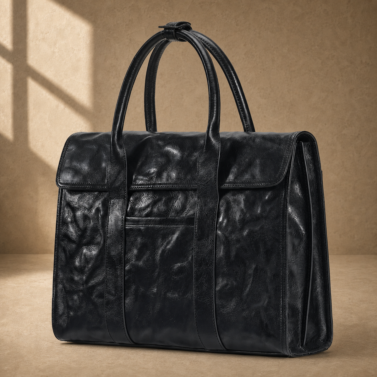 Black wrinkled leather briefcase, three-quarter front view