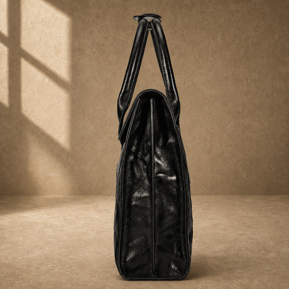 Black wrinkled leather briefcase, side profile