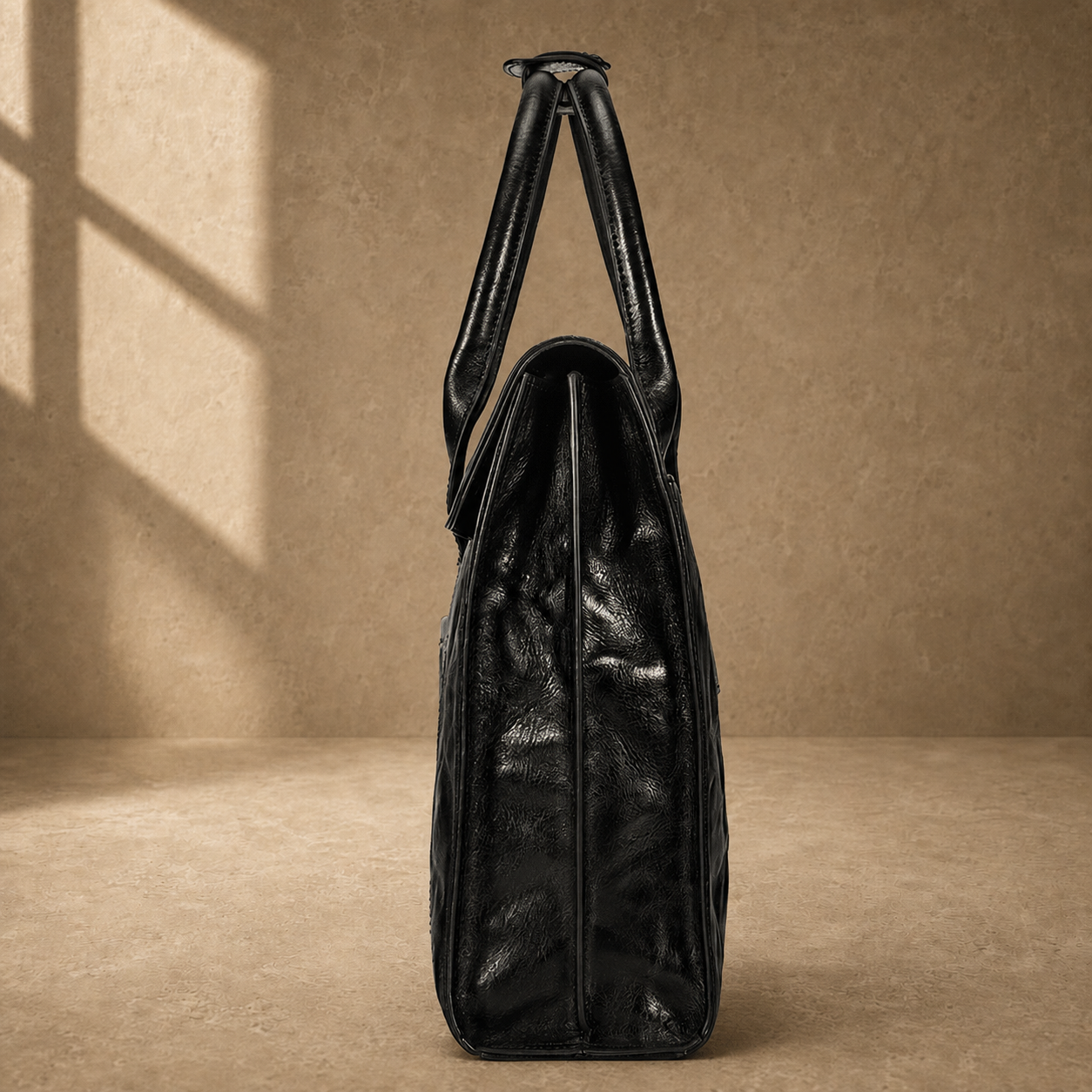 Black wrinkled leather briefcase, side profile