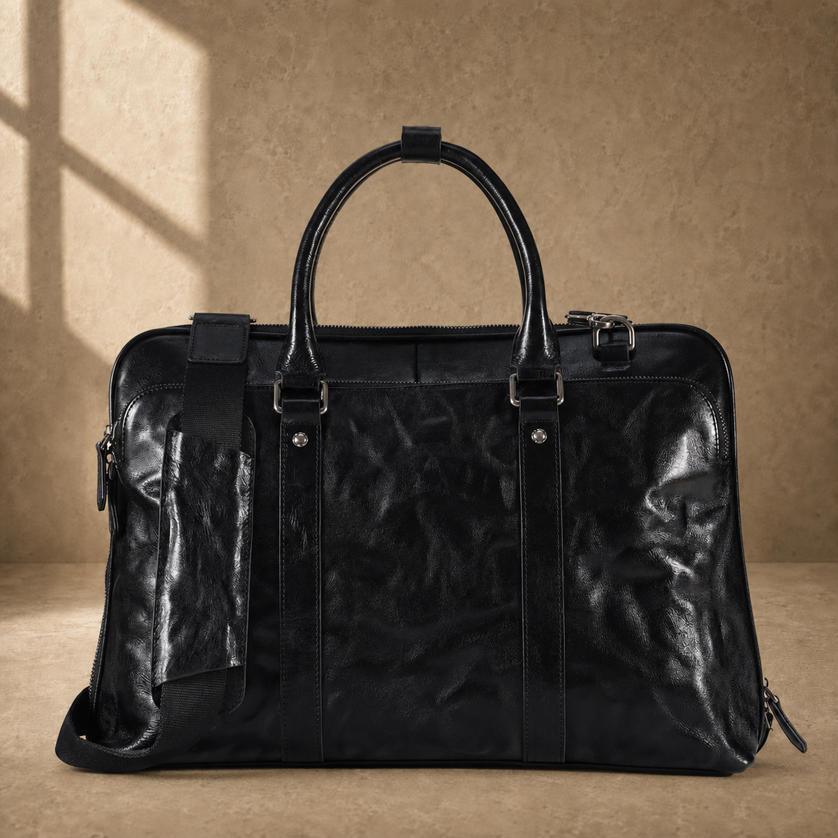 Black leather 17-inch work briefcase, front view with shoulder strap