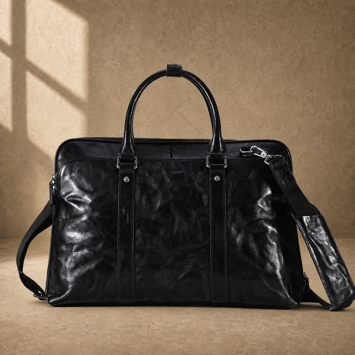 Black leather 17-inch work briefcase, front view with extended strap