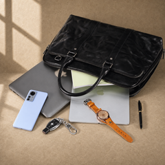 Black leather 17-inch work briefcase shown with business essentials