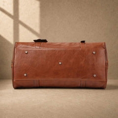 Chestnut cowhide executive weekender with protective metal feet