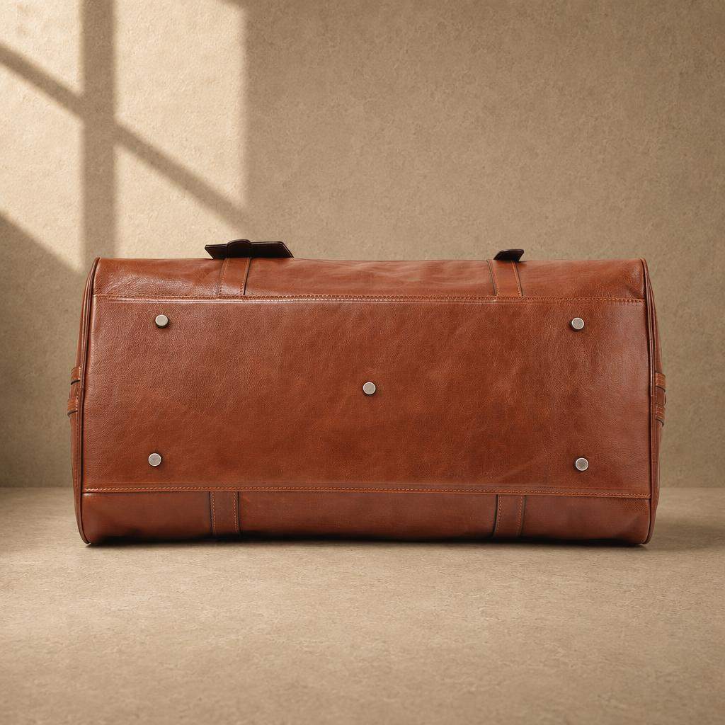 Chestnut cowhide executive weekender with protective metal feet