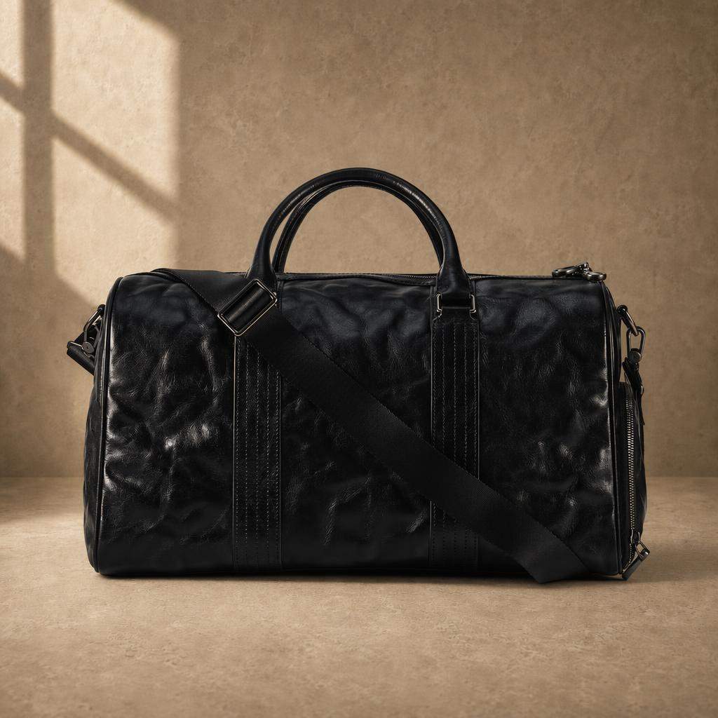 Rear view of black cowhide leather weekender with adjustable shoulder strap