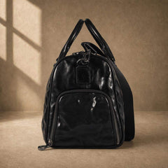 Side view of black cowhide leather weekender showing zippered shoe compartment