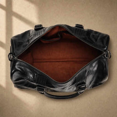 Overhead view of empty brown-lined cowhide leather weekender compartment