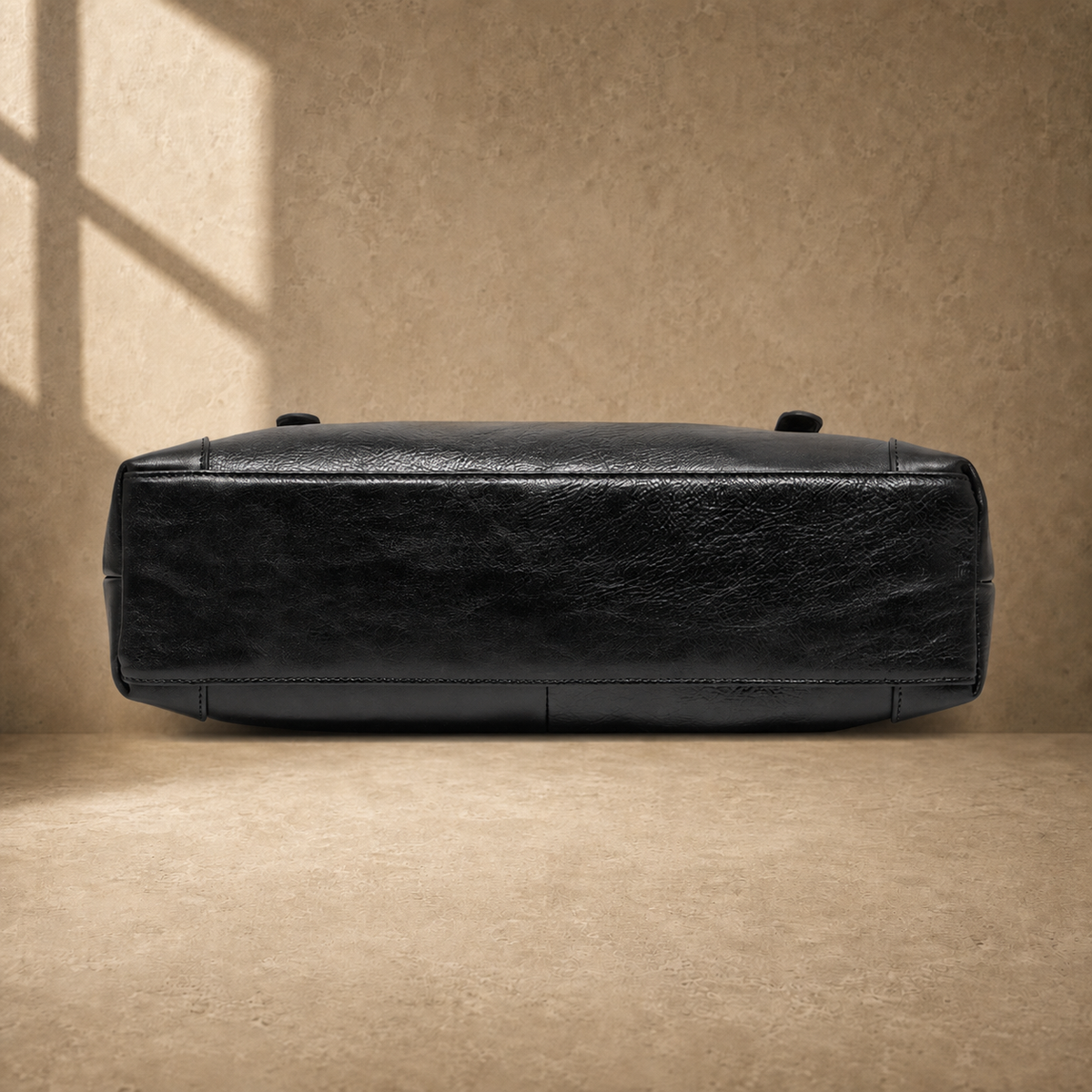 Black leather commuter messenger bag, reinforced base view