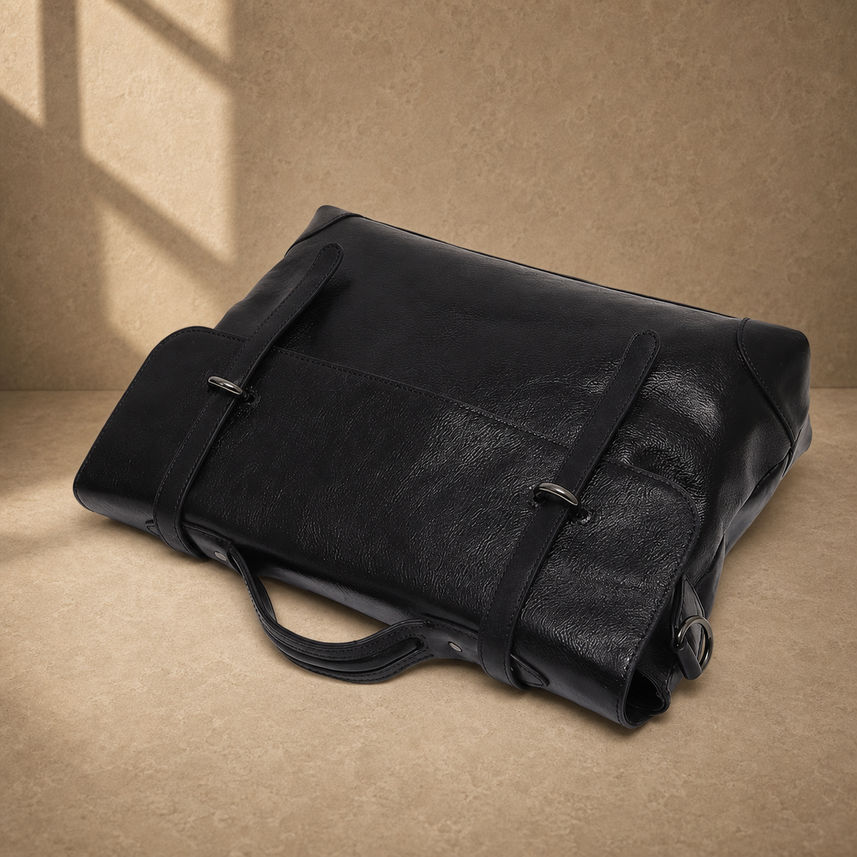 Black leather commuter messenger bag, top-down folded view