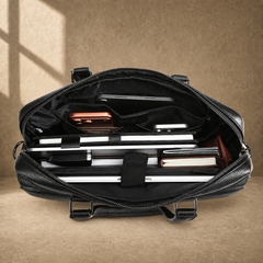 Black leather multi-pocket briefcase, packed laptop compartment