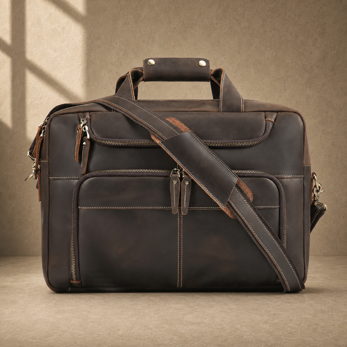 Brown leather multi-pocket briefcase with shoulder strap, front view