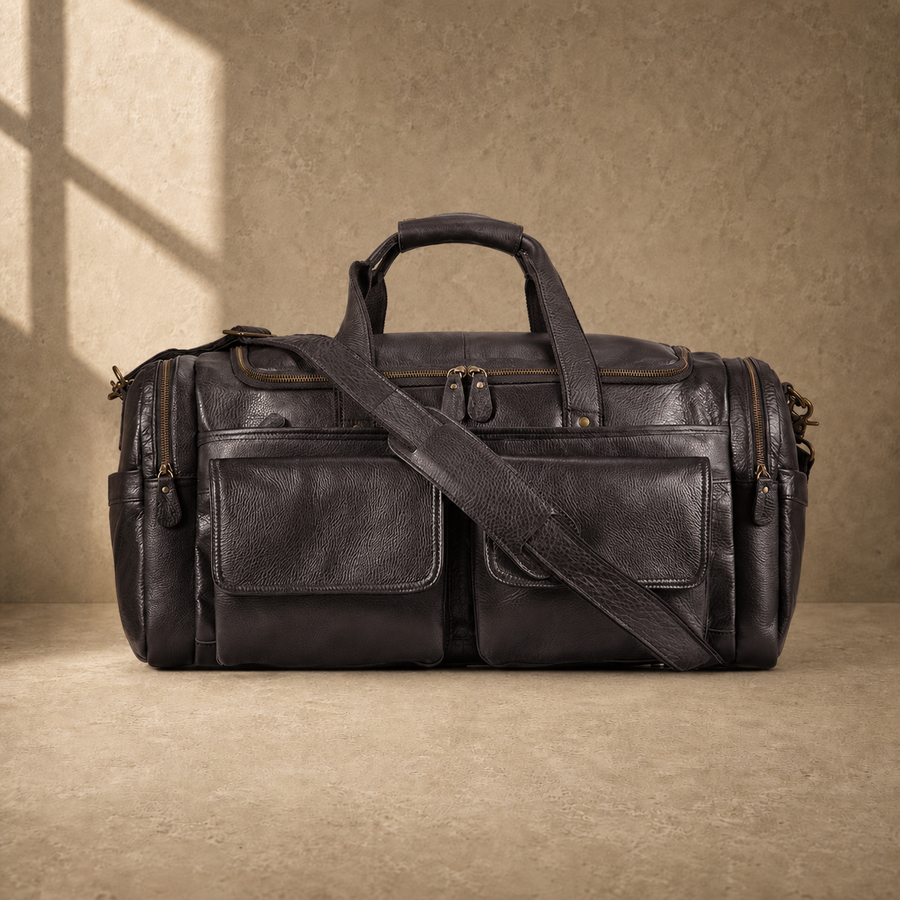 Coffee brown leather utility travel duffel with shoulder strap, front view