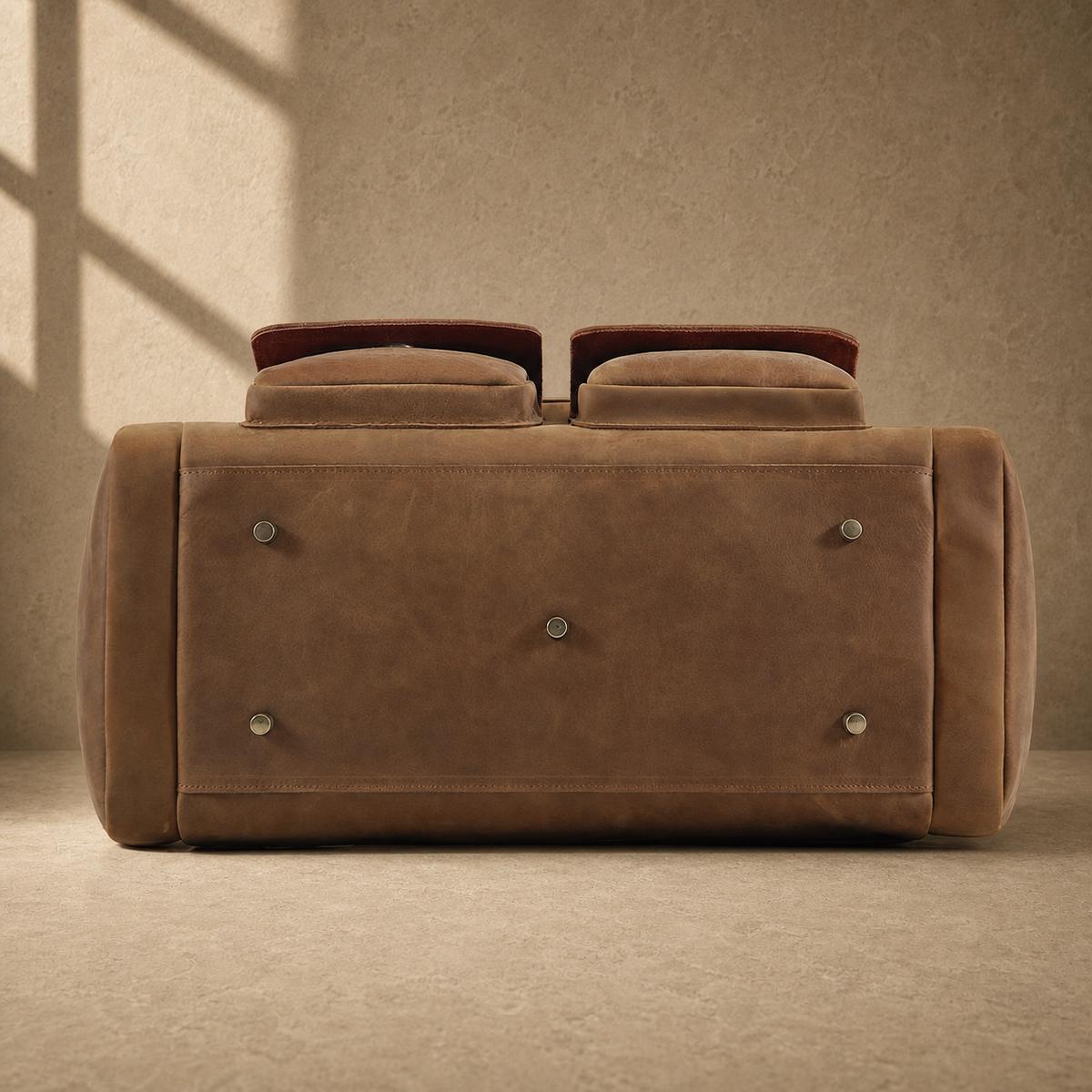 Dark brown leather utility weekender with protective metal feet