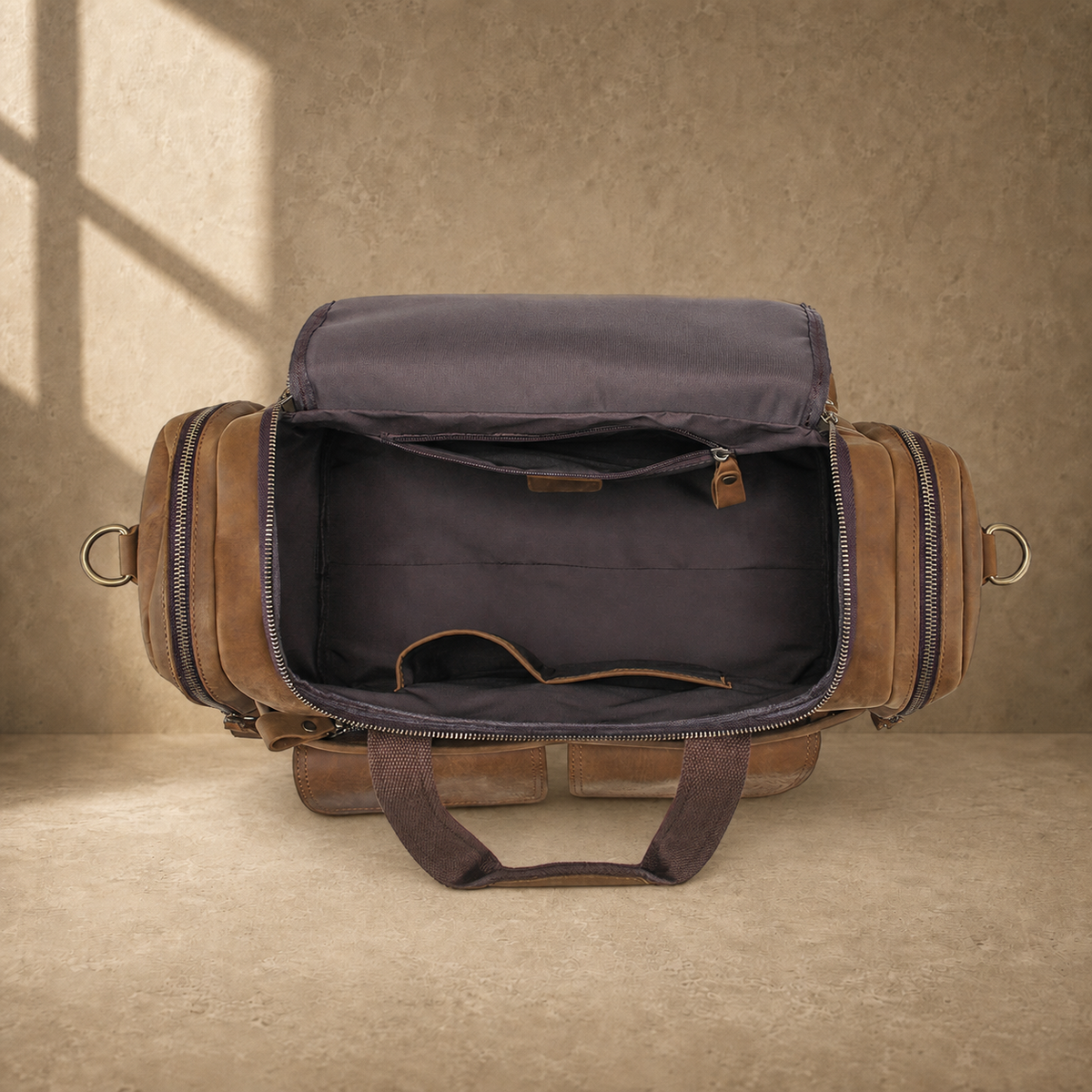 Dark brown leather utility weekender showing empty organized interior