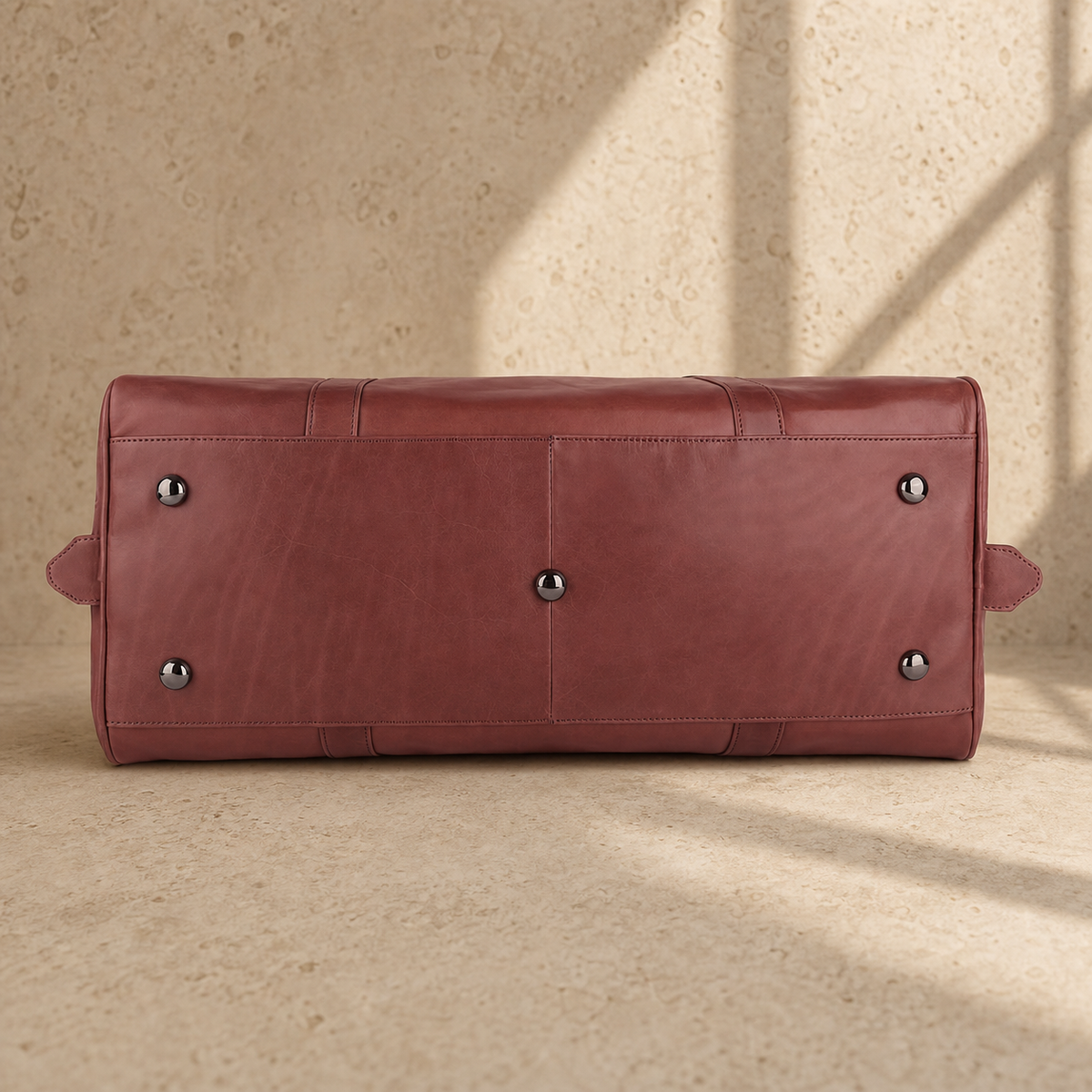 Burgundy leather large weekender bag, base and protective feet