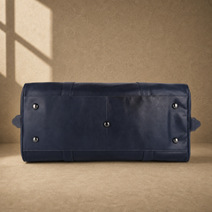 Navy structured buckle travel duffel with protective base feet