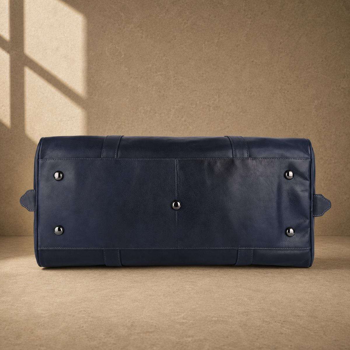 Navy structured buckle travel duffel with protective base feet