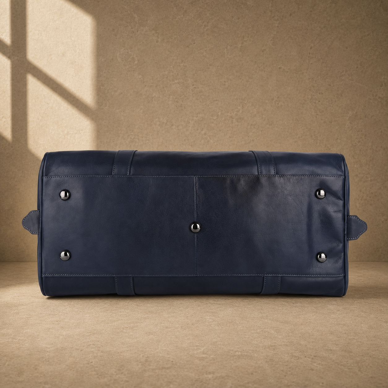 Navy structured buckle travel duffel with protective base feet