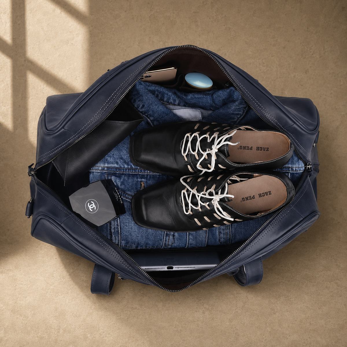 Navy structured buckle travel duffel showing packed capacity