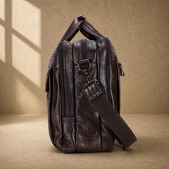 Coffee brown leather laptop work bag, side profile with shoulder strap