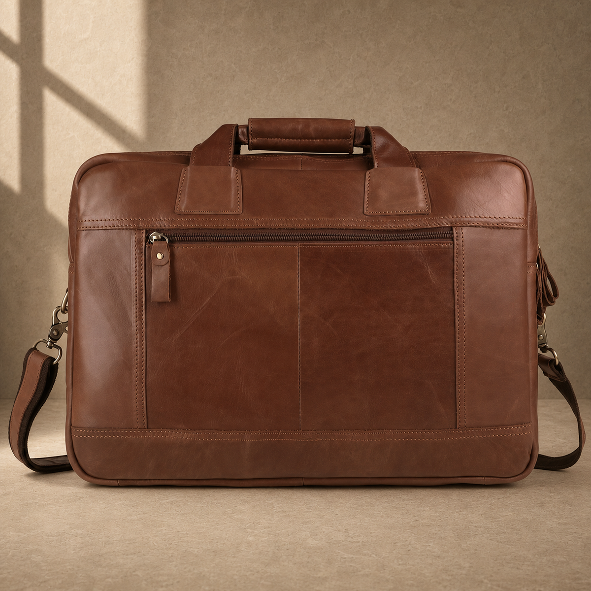Brown cowhide dual-zip briefcase bag, rear zipper pocket view