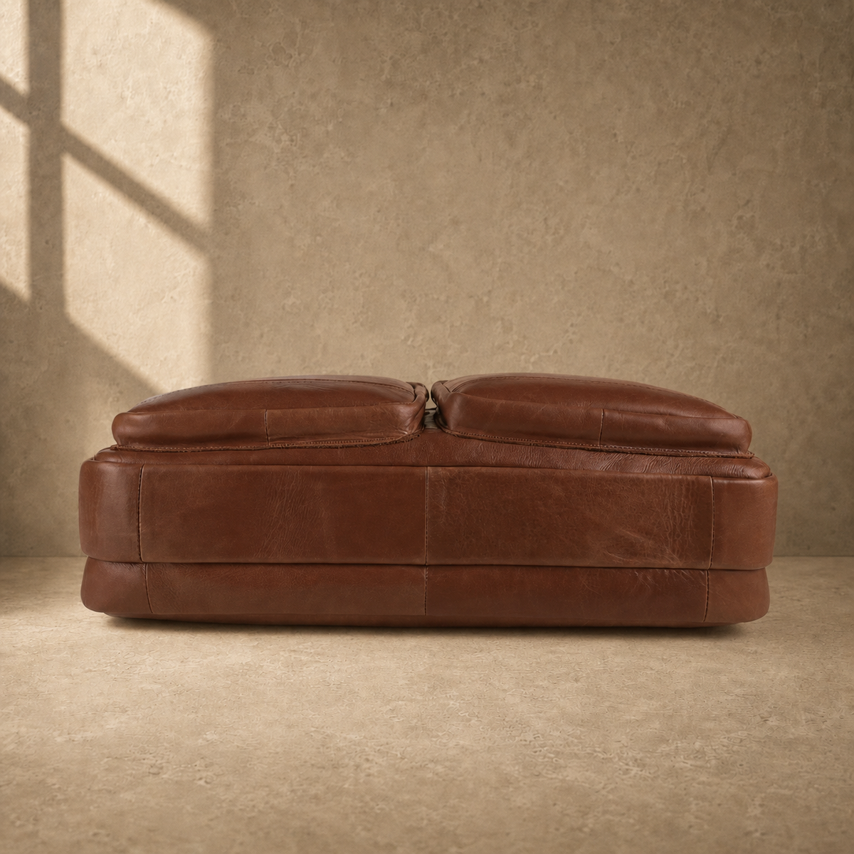 Brown cowhide dual-zip briefcase bag, reinforced base view