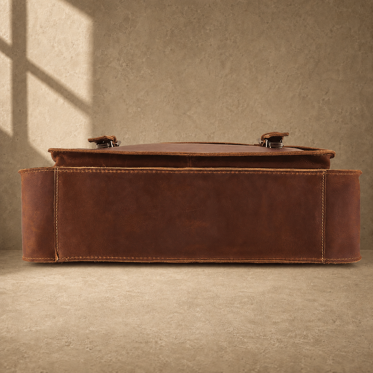 Brown leather buckled work briefcase reinforced base view
