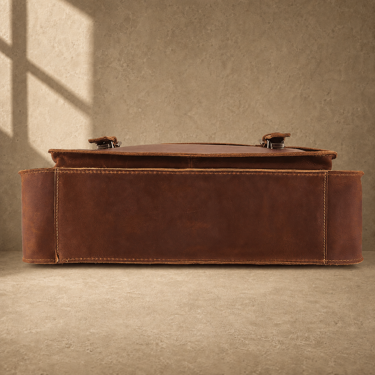Brown leather buckled work briefcase reinforced base view