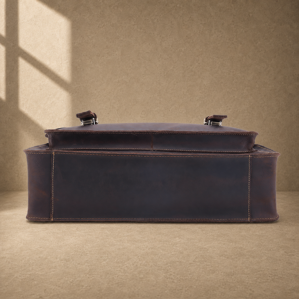 Coffee brown leather buckle briefcase reinforced base view