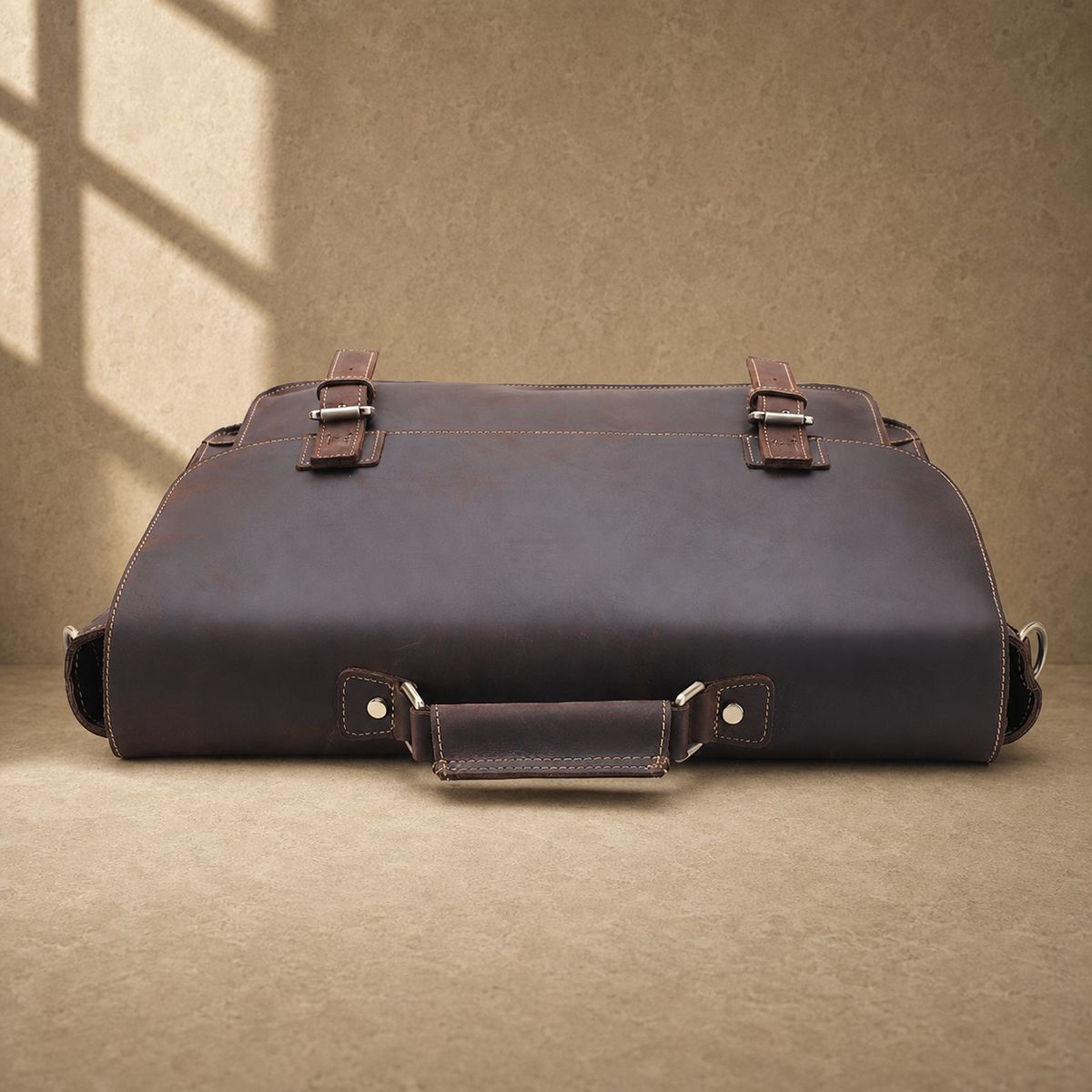 Coffee brown leather buckle briefcase top and handle construction view