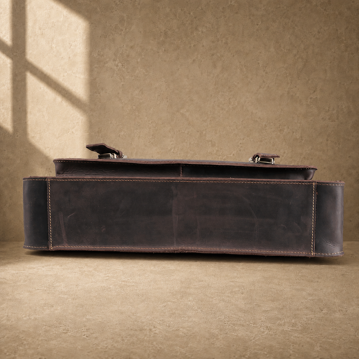 Deep coffee leather buckle briefcase reinforced base view