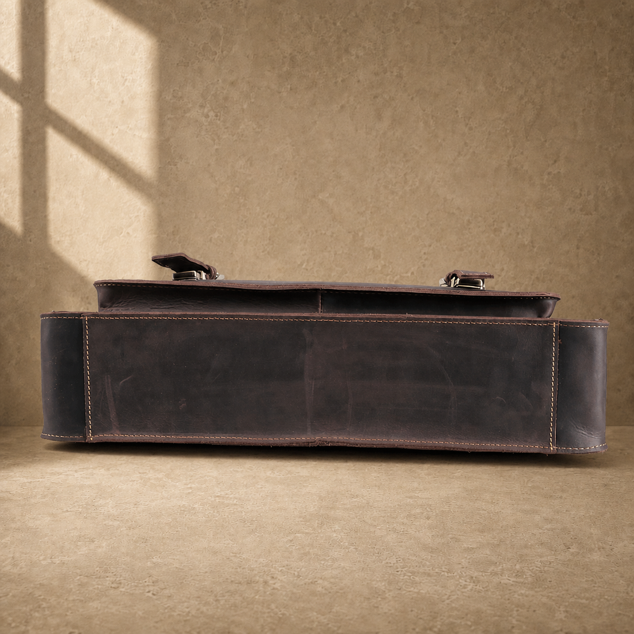 Deep coffee leather buckle briefcase reinforced base view