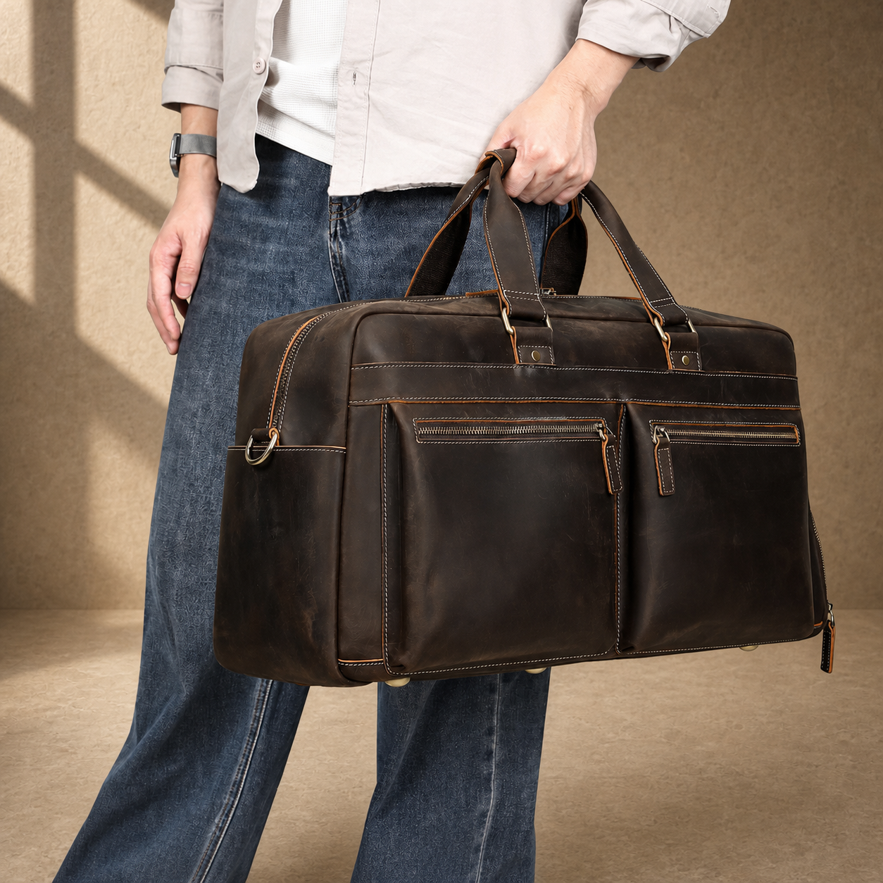 Deep coffee leather weekender duffle, hand-carry lifestyle view