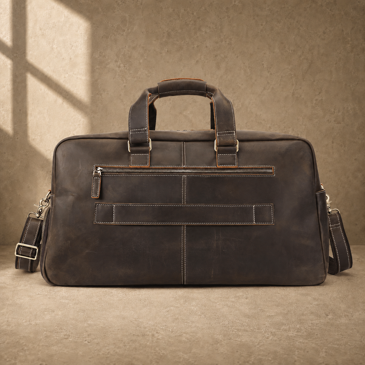 Deep coffee leather weekender duffle, rear luggage sleeve view